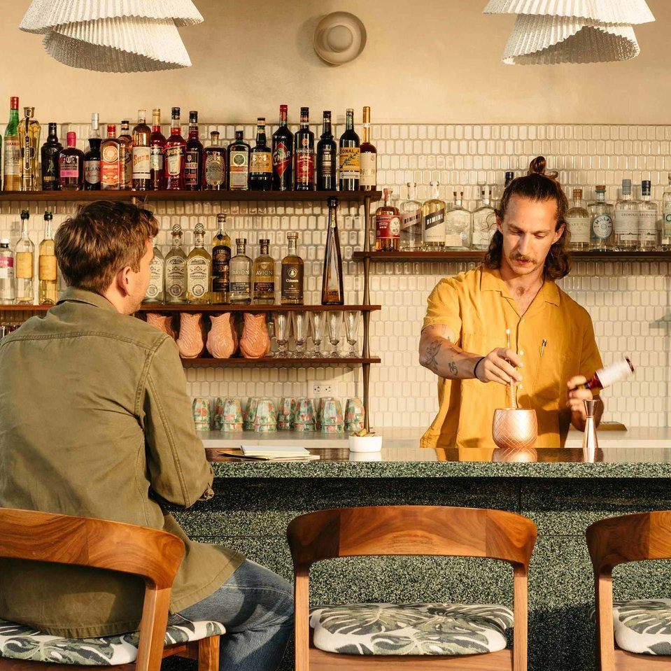 Bartender serving a guest at the rooftop restaurant at The Hox, DTLA