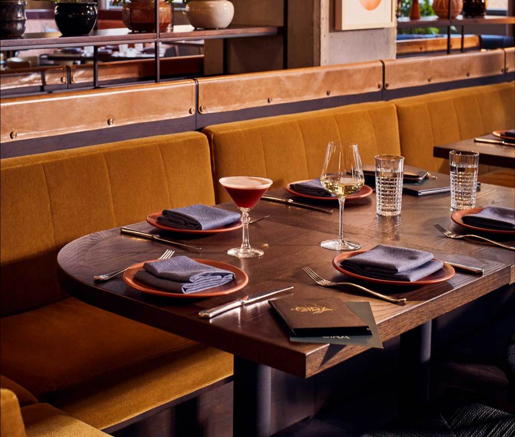 A cocktail and glass of wine sit waiting for guests at a table