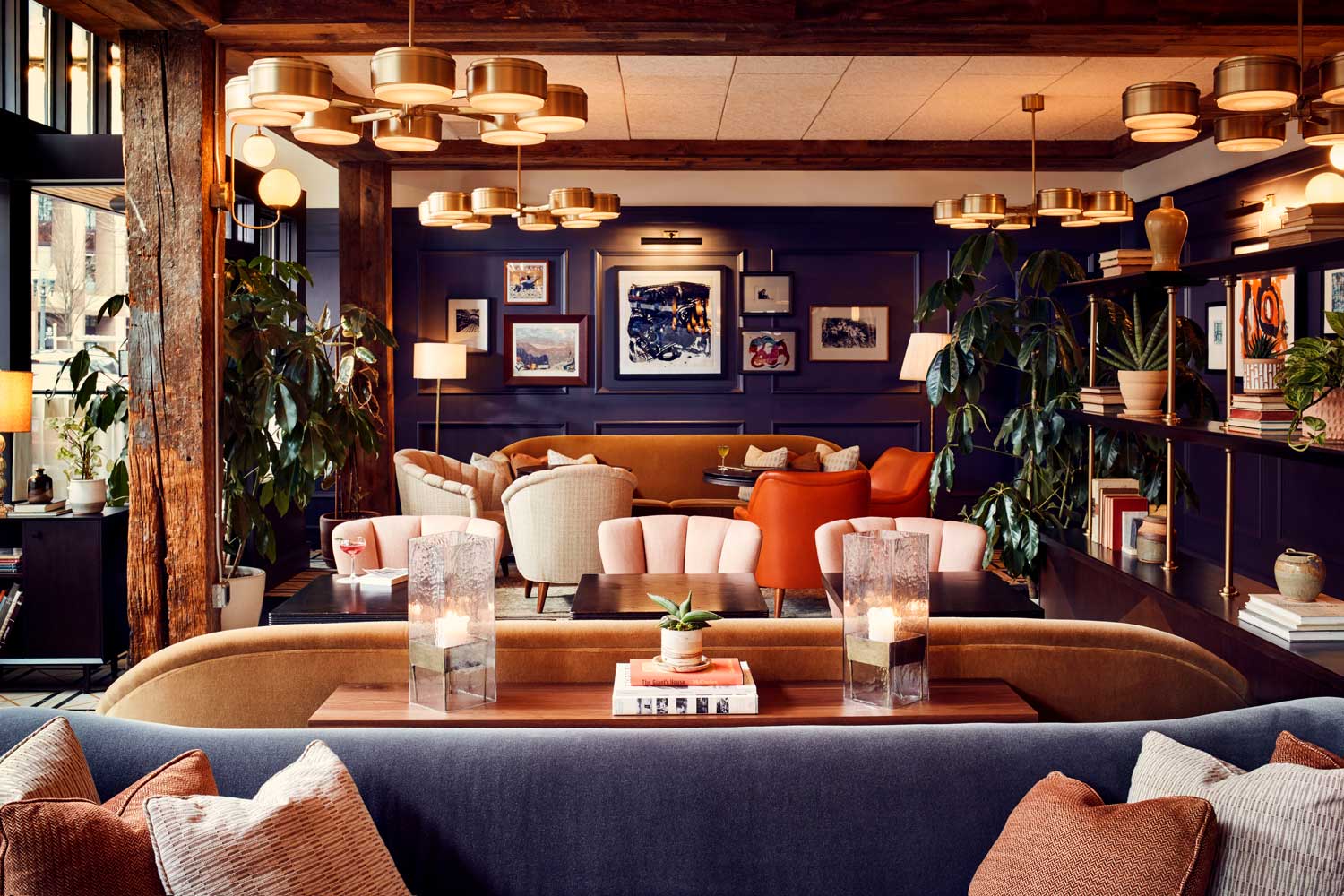 The restaurant interior is very colourful, with dark blue walls and light pink, dark orange and light beige seating