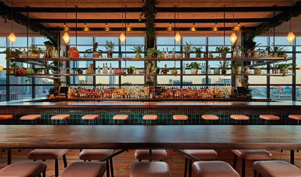 The bar has an expansive selection of both drinks and seating, with a gorgeous view of Chicago's skyline behind it