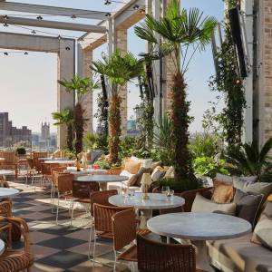 Empty tables ready for service on the outside terrace of the rooftop restaurant Seabird