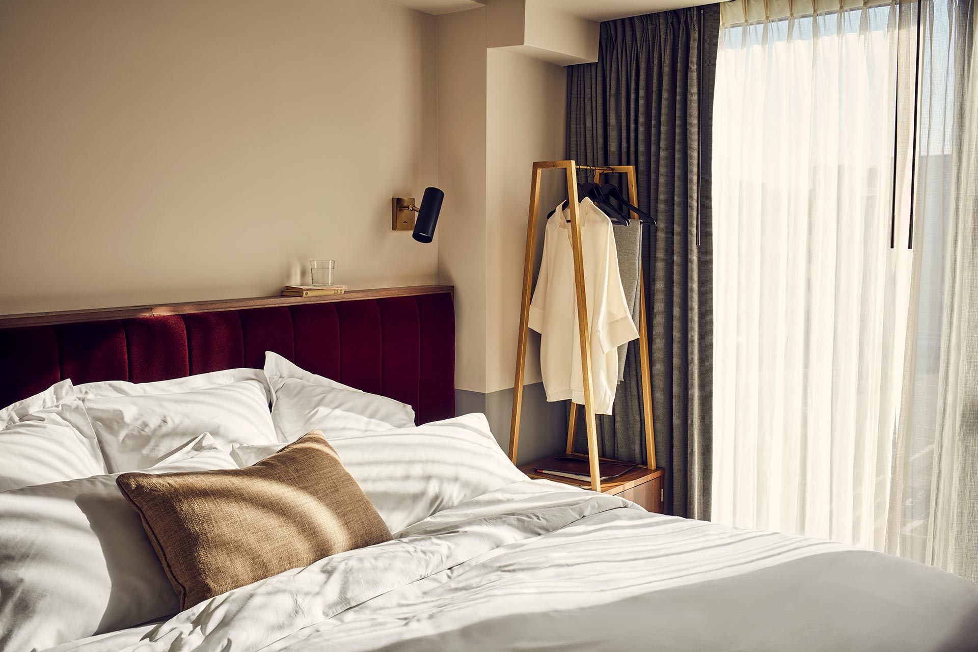 Interior of the room showing a portion of the bed with sunlight falling across it.