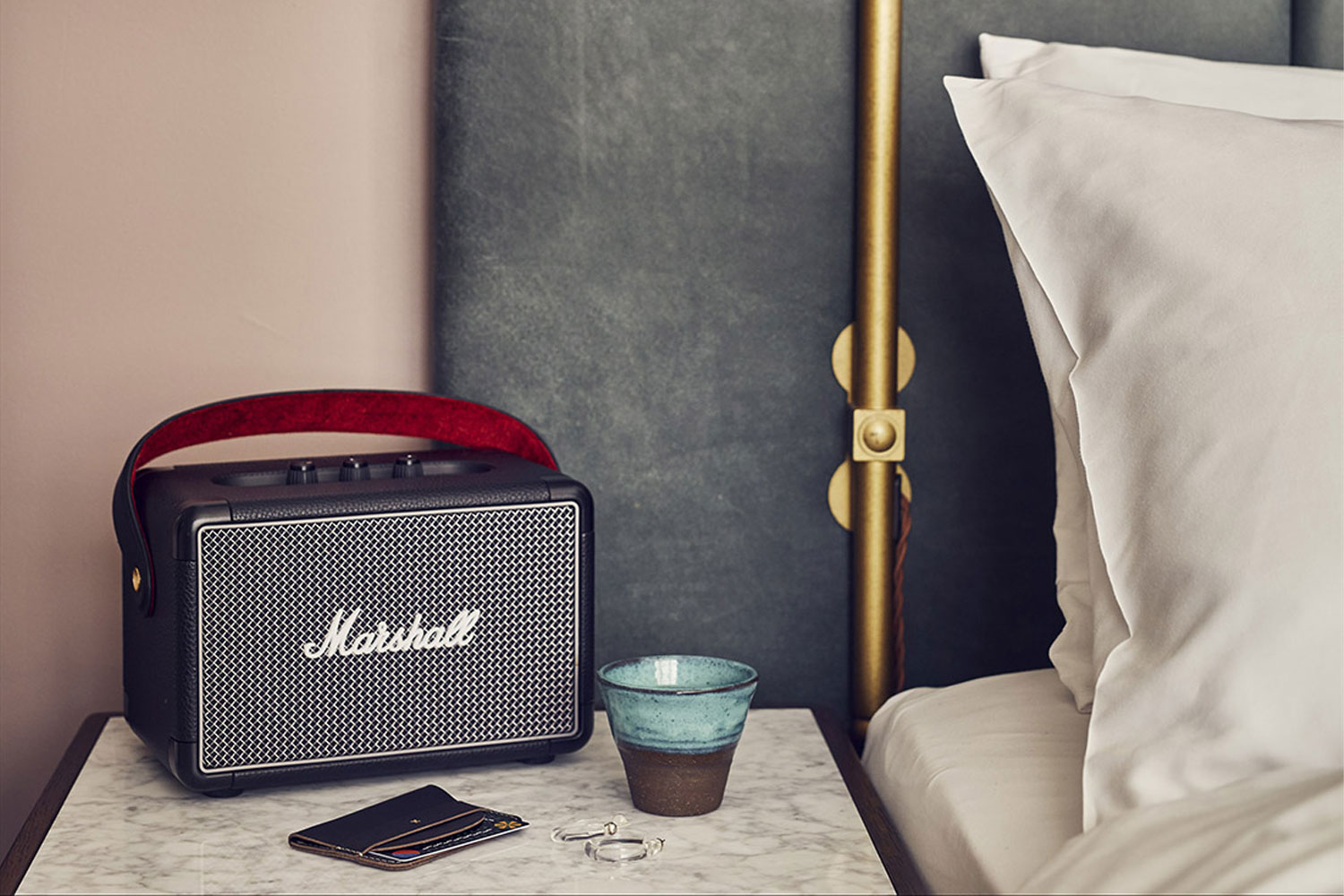 Marshall bluetooth speaker beside bed