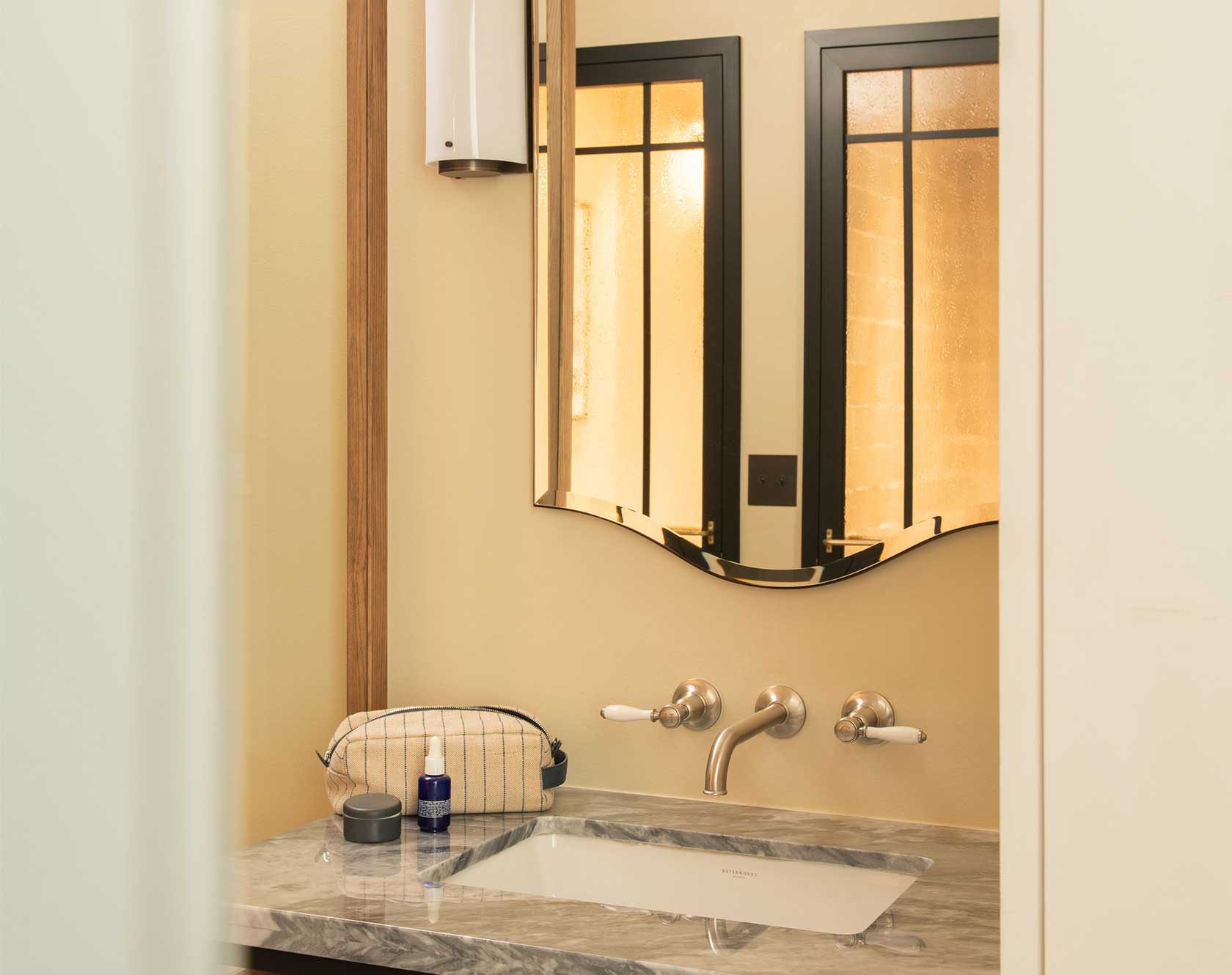 A large mirror sits above the sink in the ensuite bathroom.