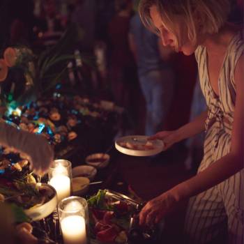 Woman getting food from a table at a party