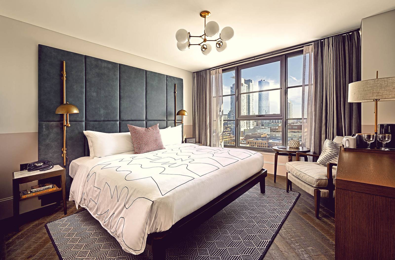 King sized bed in a hotel room that has stunning views across Chicago