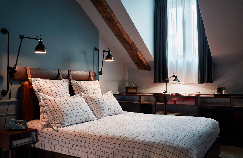 Double bed in a room with sloped ceiling