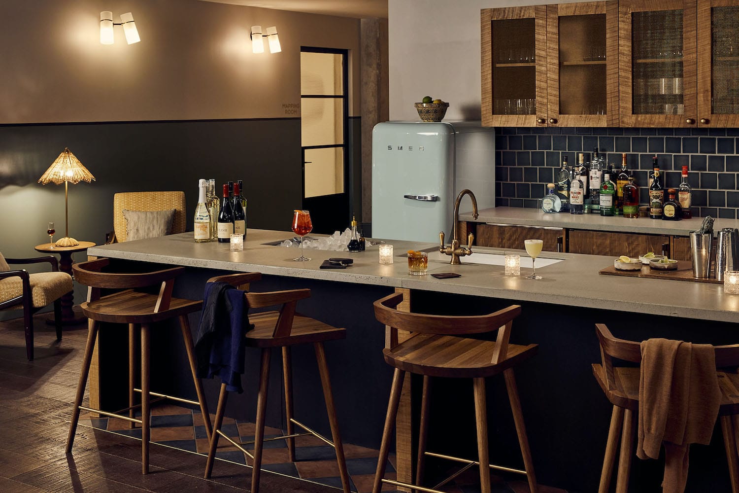 Pantry kitchen set up for guests in the evening, with cocktails and wine bottles on the side