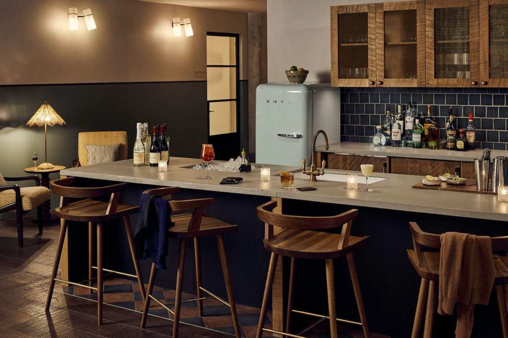 Pantry kitchen set up for guests in the evening, with cocktails and wine bottles on the side