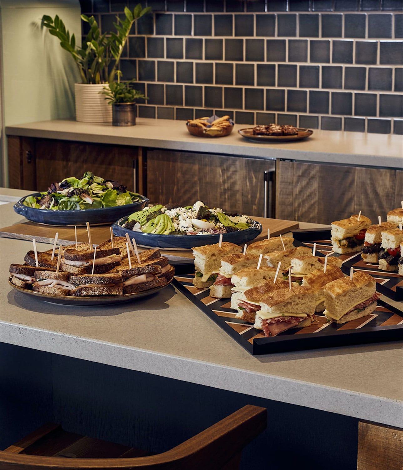 Platters of food laid out in the pantry kitchen of The Apartment