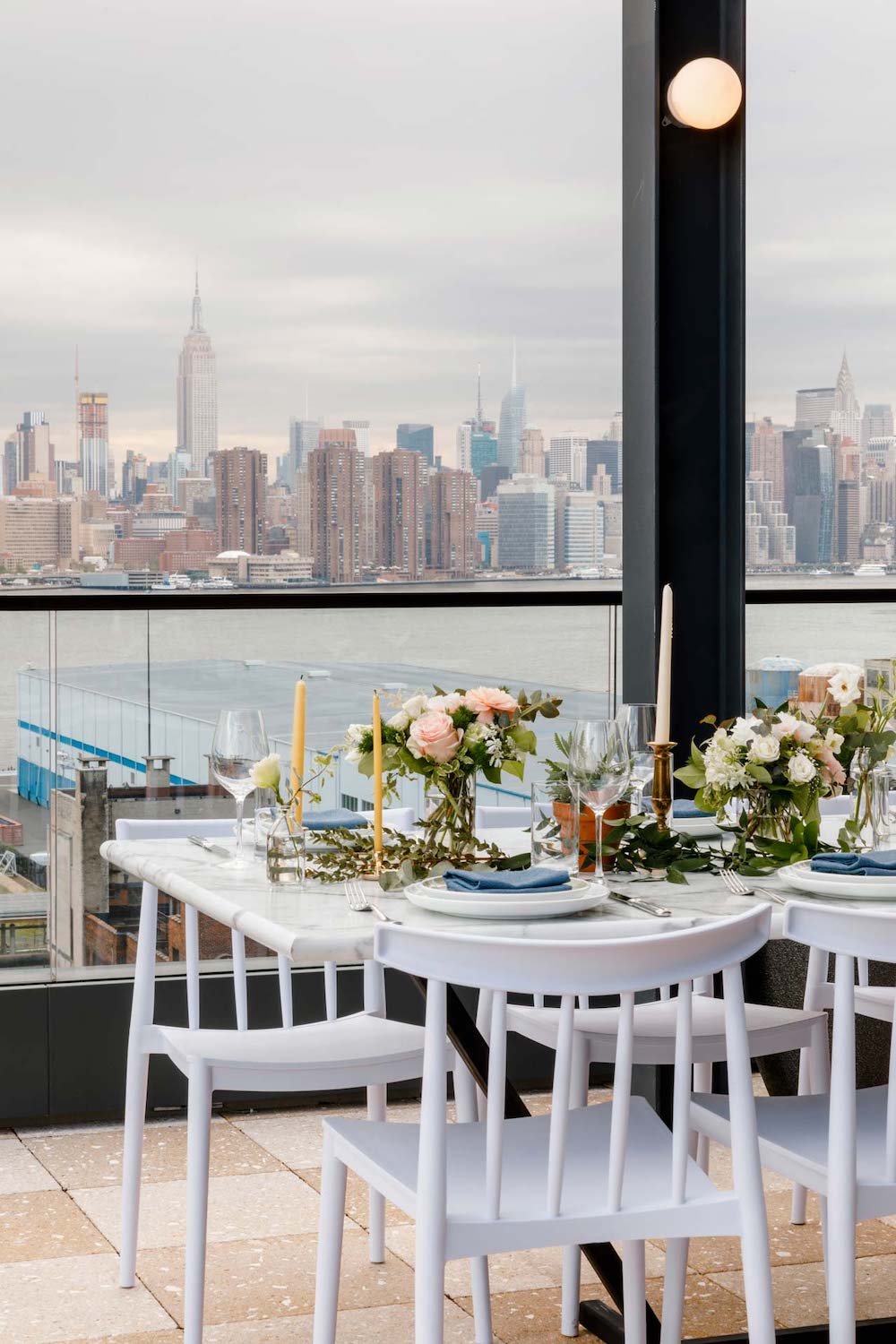 Beautiful place setting on a table in front of Manhattan skyline