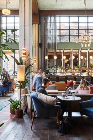 Guests on laptops or meeting friends for a drink in the hotel lobby