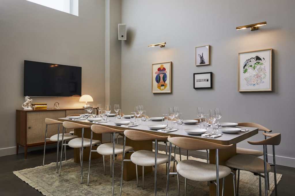 Twelve place settings ready for diners on a table in the Study