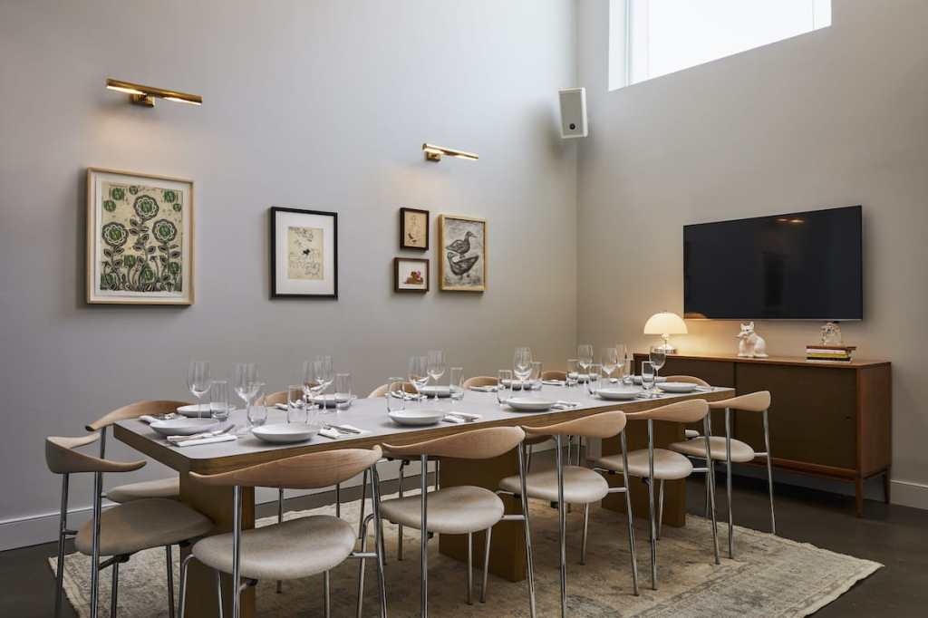 A room set up for 12 diners, with glassware and plates