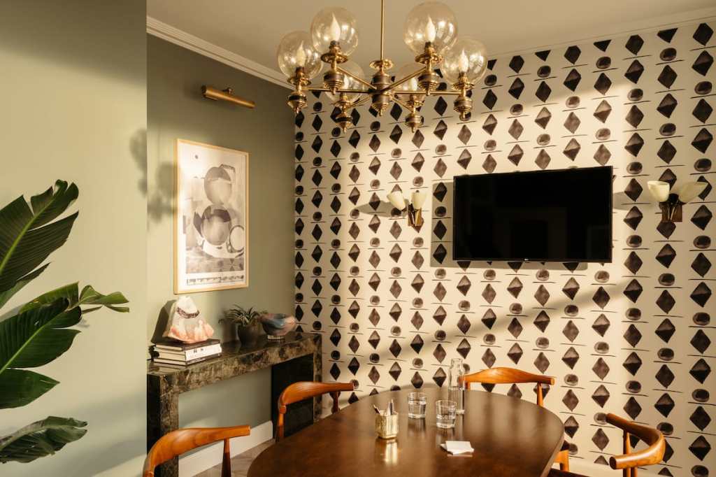 Smaller meeting space with TV on the wall and natural light