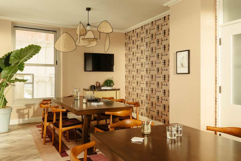 Sunroom Meeting Space with natural light and potted plant.