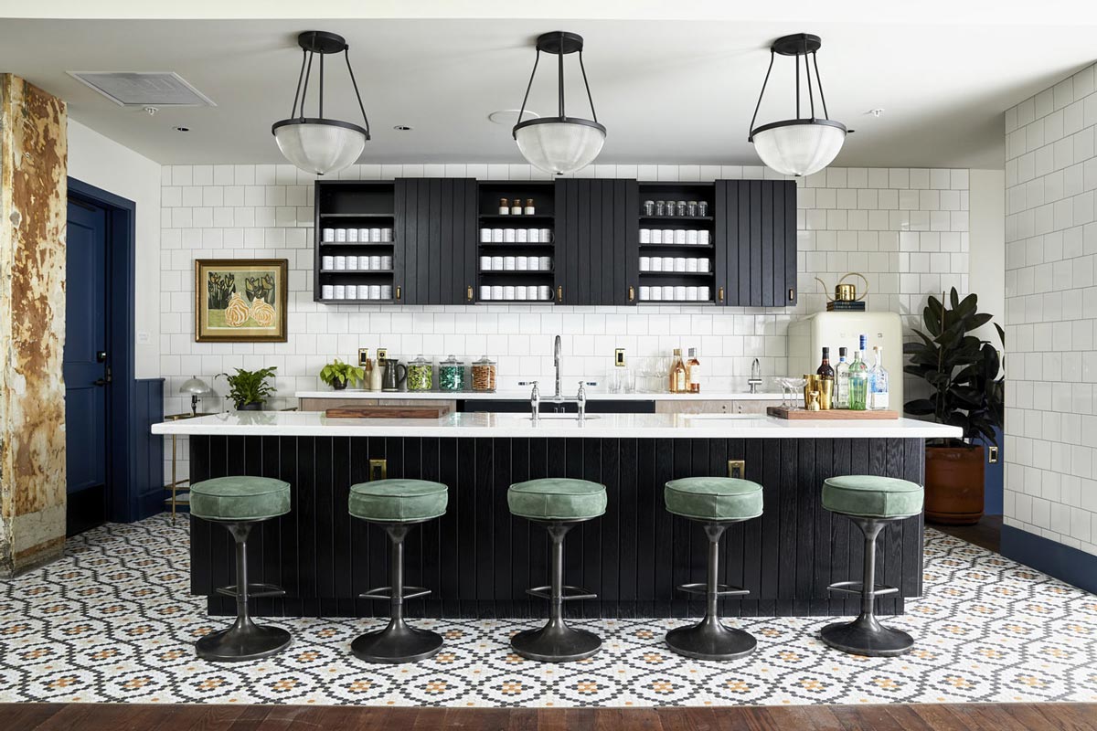 Pantry area, with five green coloured bar stools in front of the kitchen island