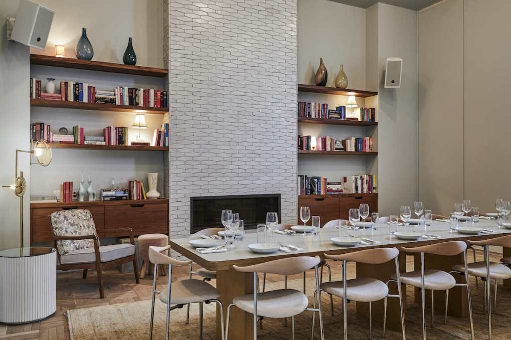 Private dining set up in Dining Room, with the fireplace and bookshelves in the background