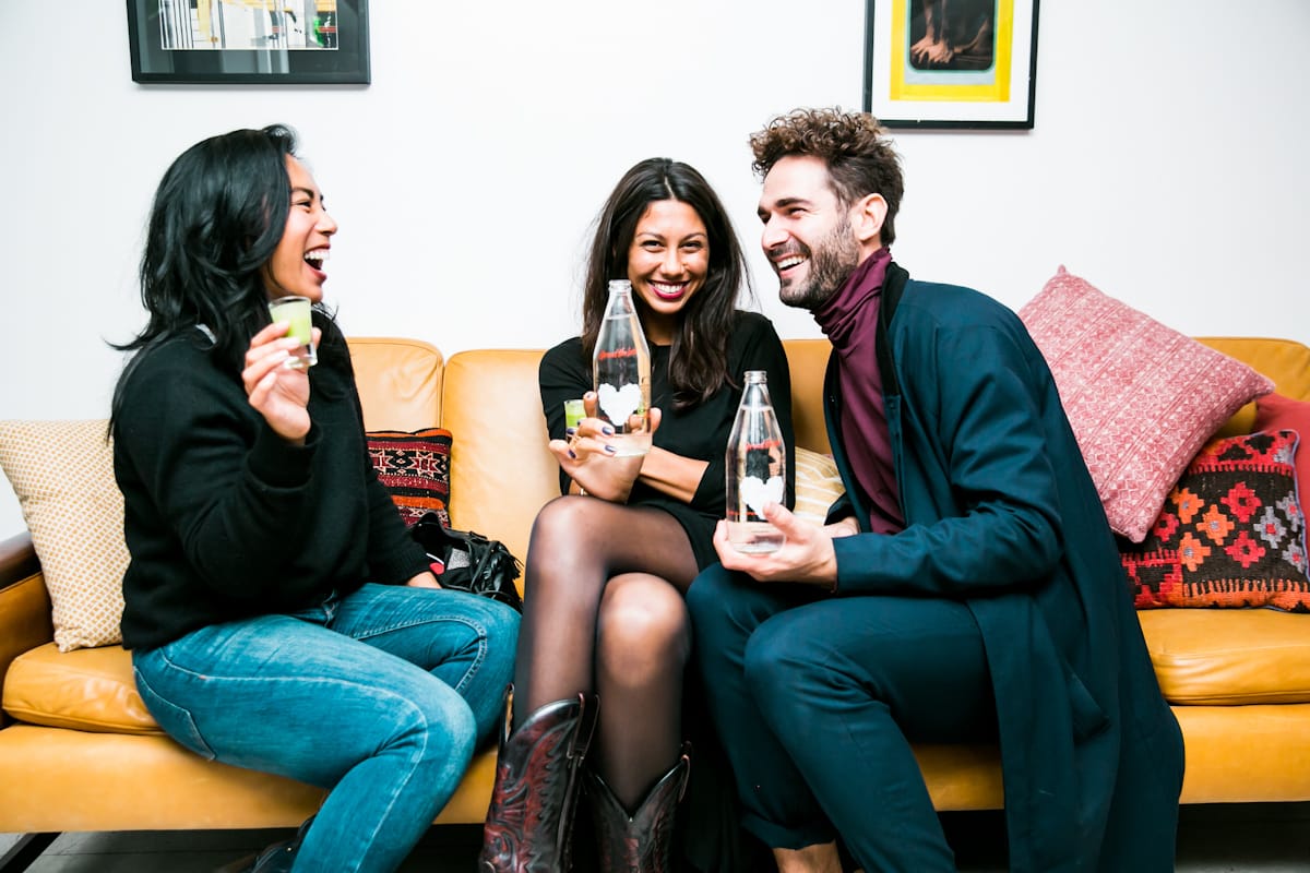 Three friends having fun with drinks