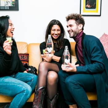 Three friends having fun with drinks