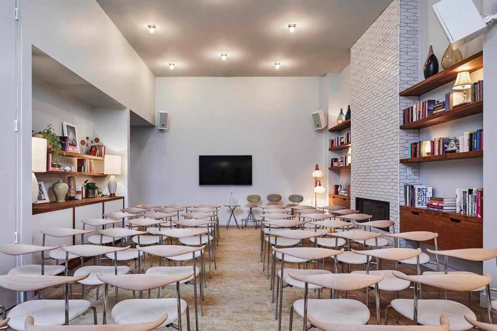 Play room and dining room set up in theatre layout with rows of seats facing an optional screen.