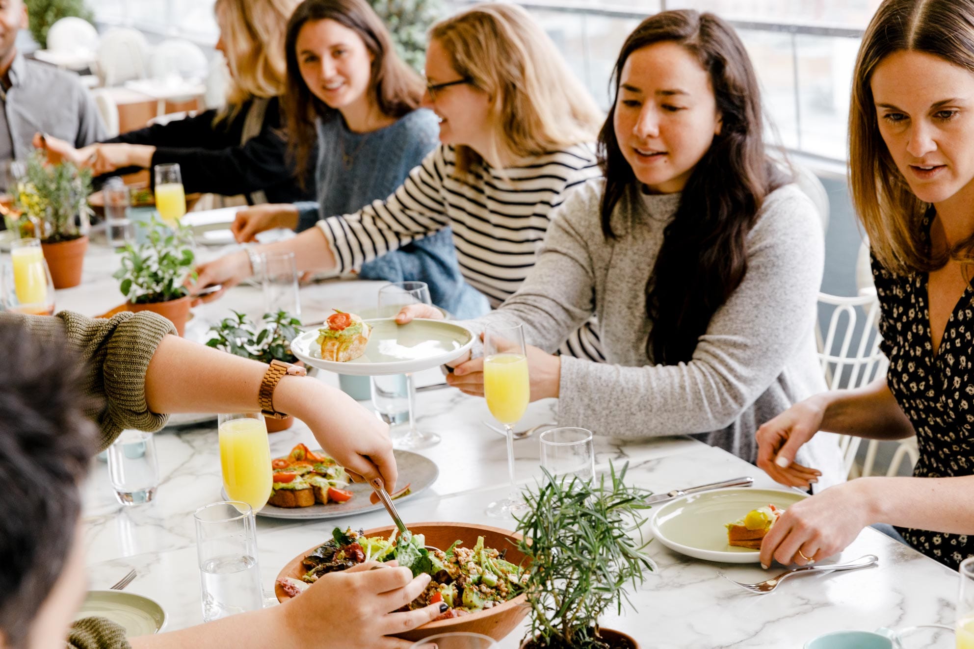 Friends sharing food and mimosas