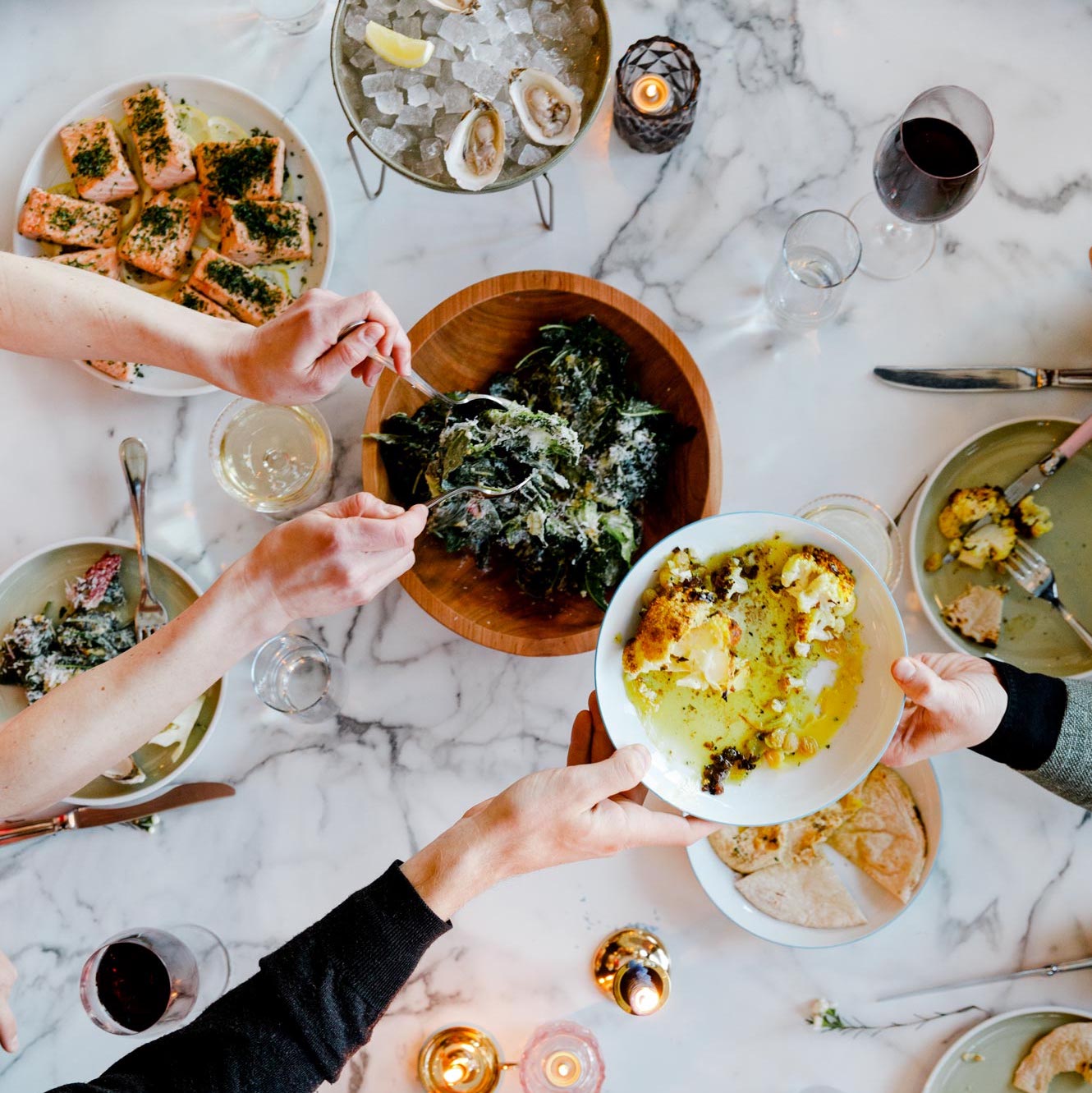 Shared plates of food on a table, taken from above