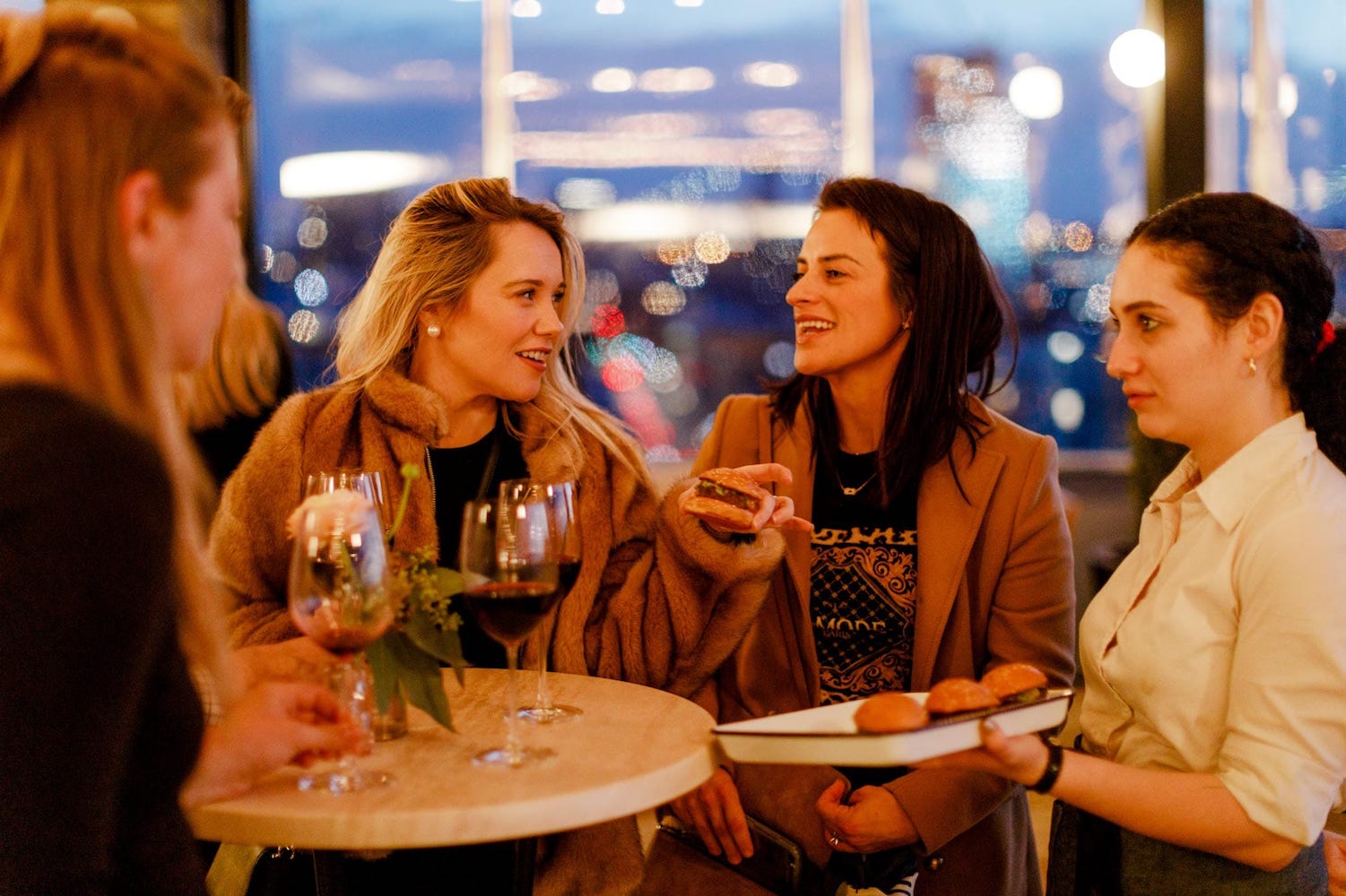 Friends enjoying food and wine at a party
