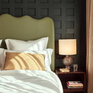 A lamp and books beside the bed