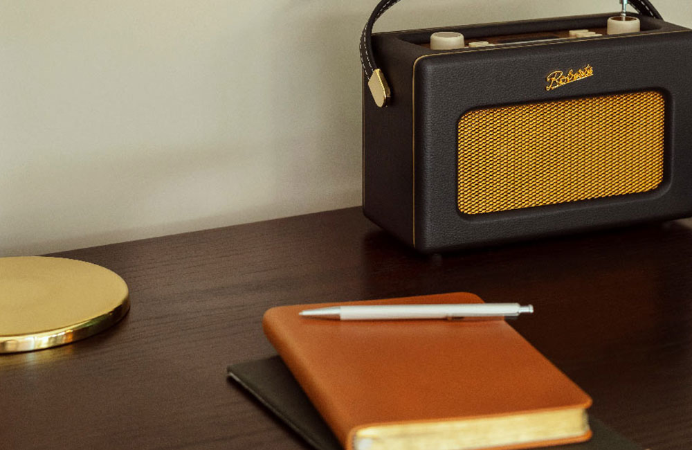 Roberts radio and notebooks with a pen