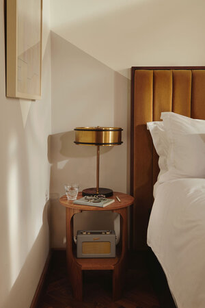 Side table in hotel room with Roberts Radio and lamp