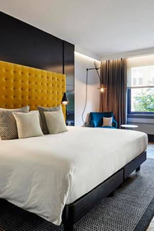 Large hotel room in Shoreditch with yellow head board