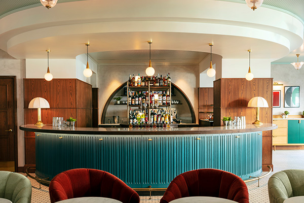 oval shaped bar with a lot of natural light and soft seating.