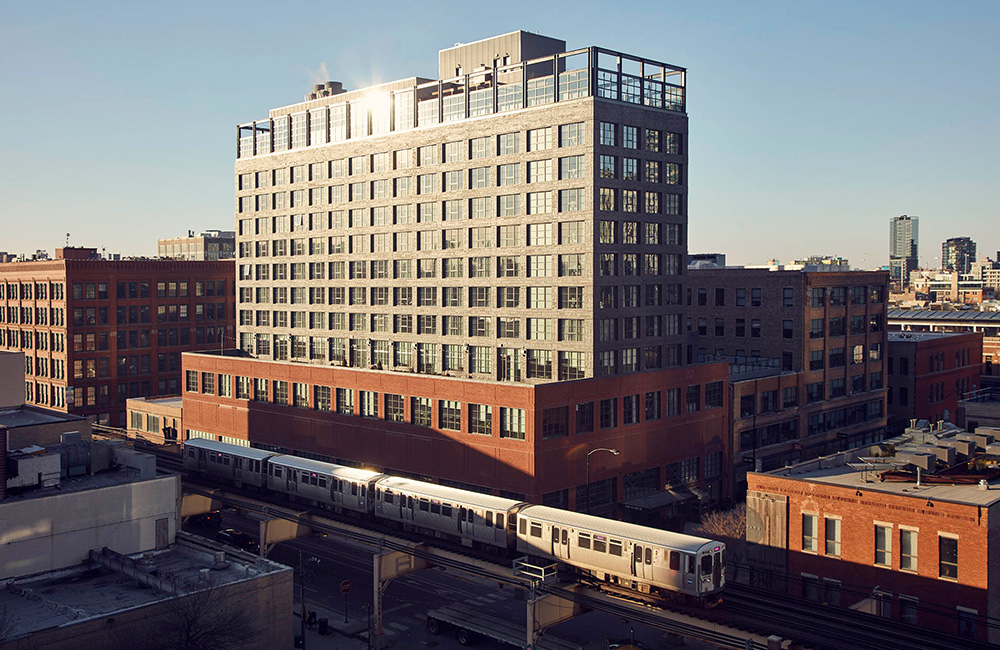 A train runs in front of The Hoxton, Chicago