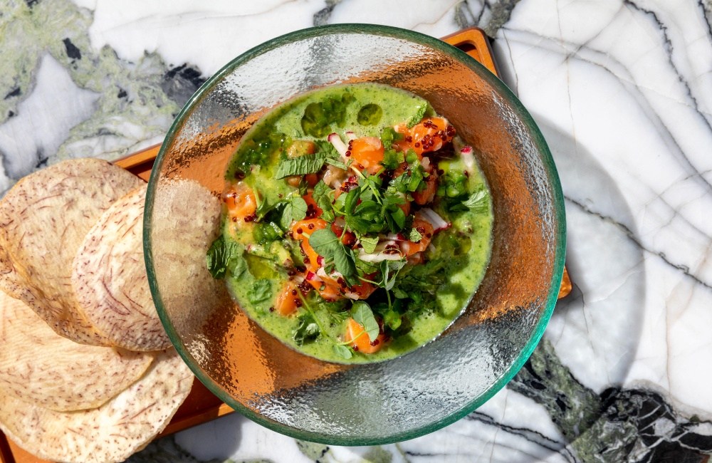 Vibrant green dish served in a deep clear glass bowl.