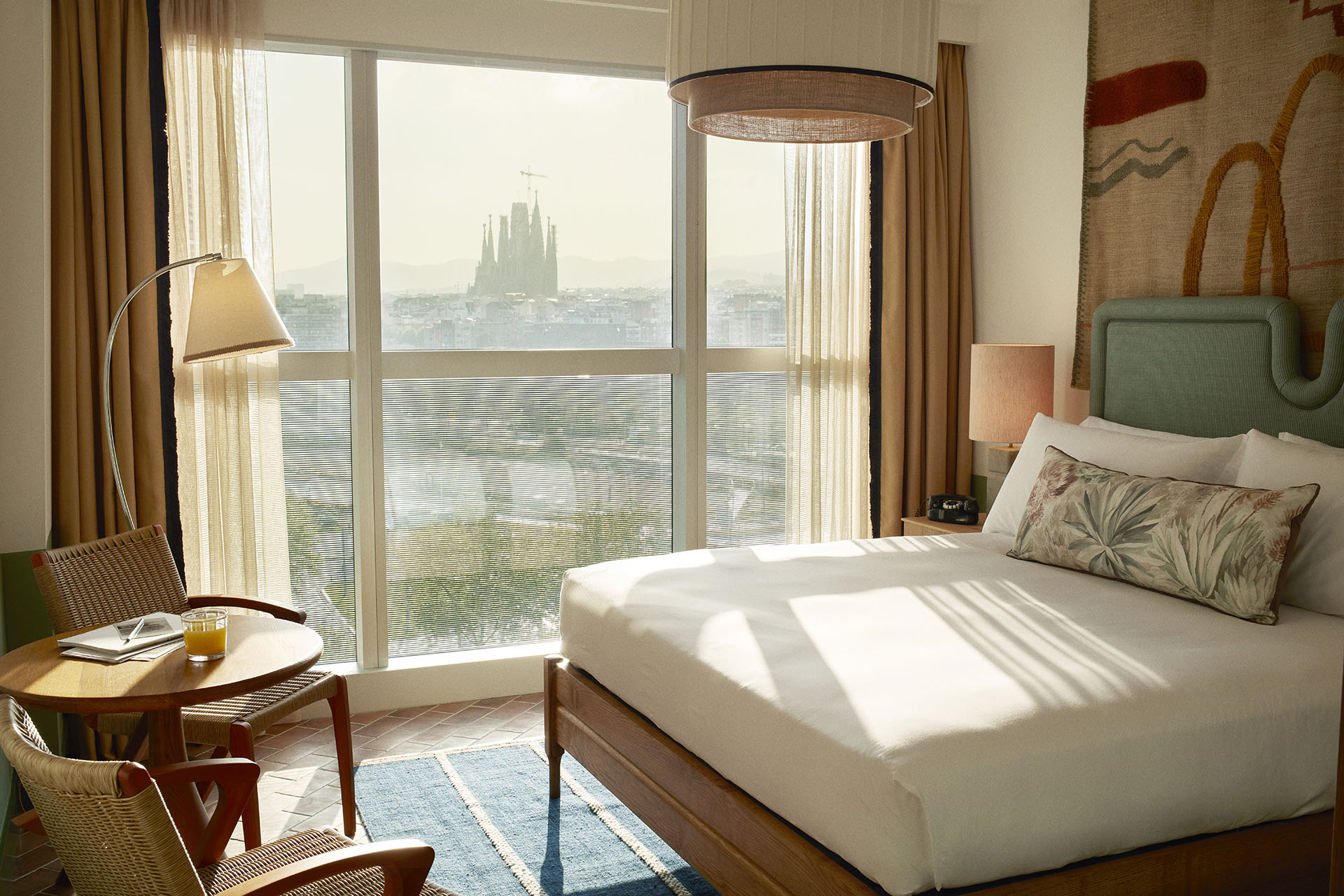 The hotel room has large windows with a beautiful view across Barcelona, with Sagrada Familia in the distaance