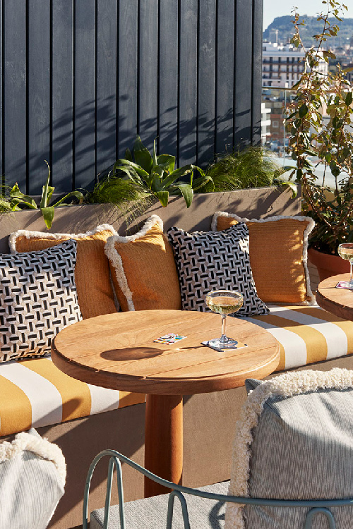 Glass of cava on table with cushions behind