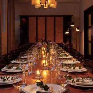 Table laid out with wine glasses, plates and candles for a gathering or party