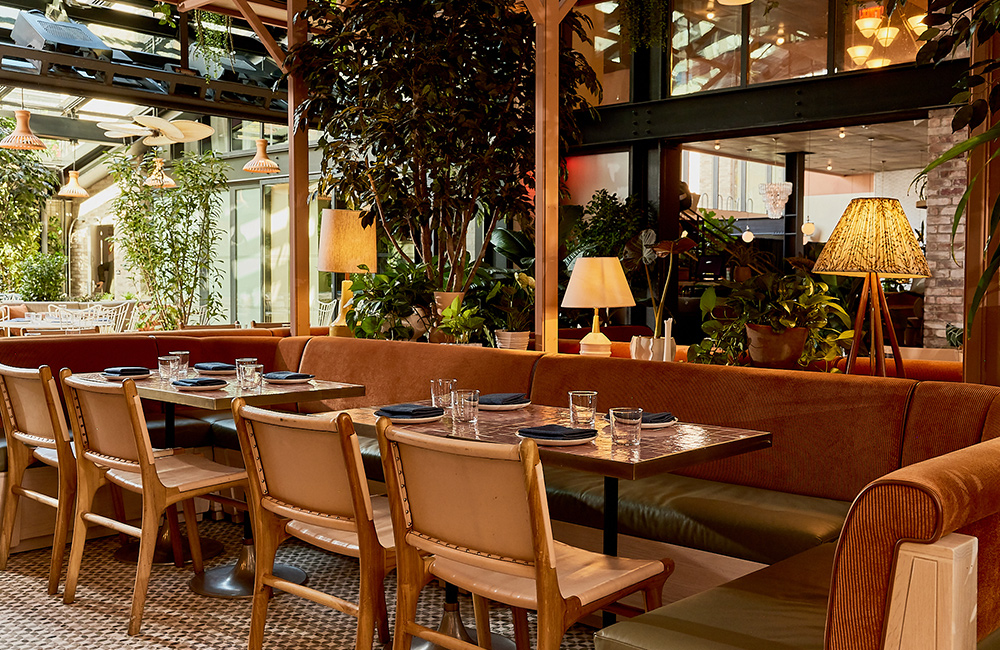 Chairs and tables with views out onto the lush patio.