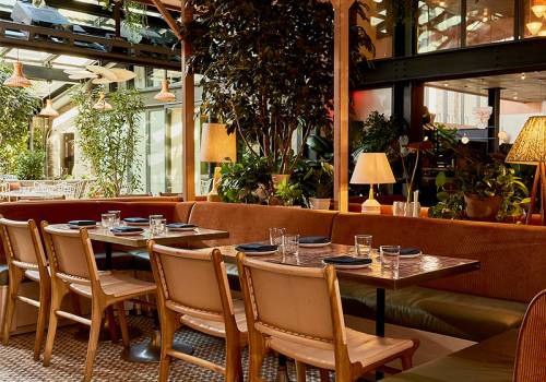 Wooden seats and shiny tables with stylish lamps at K'Far.