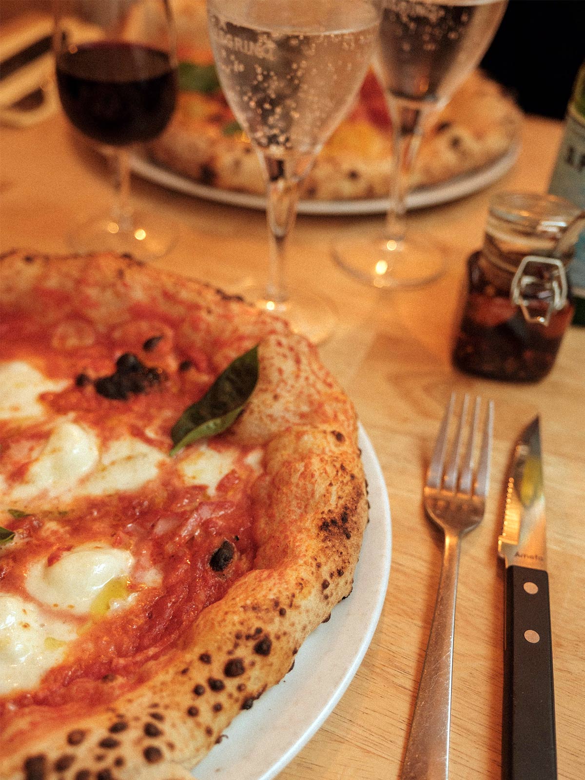 Delicious margarita pizza served at a table inside La Piola.