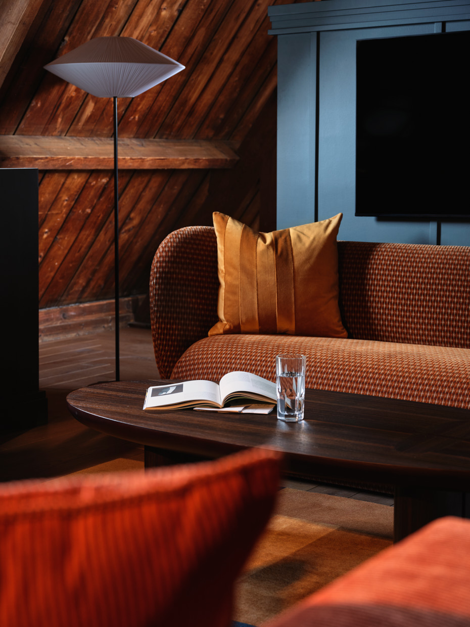 Close up of coffee table with cushioned sofas and standing lamp