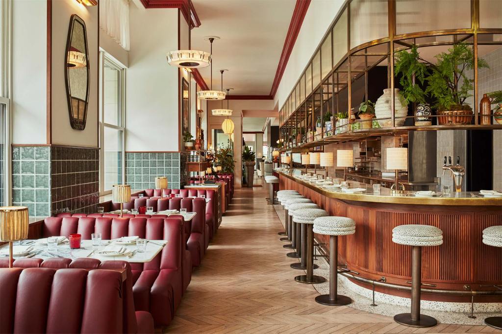 Hoxton Downtown LA interior with diner seats, bar stools, parquet floors and mauve leather and wood upholstery.