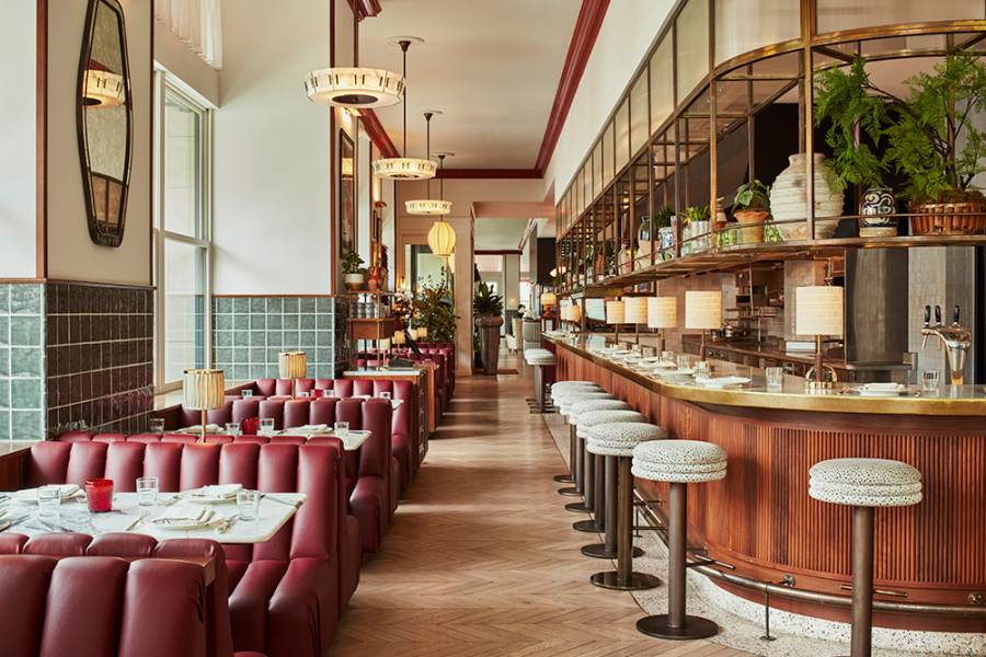 Hoxton Downtown LA interior with diner seats, bar stools, parquet floors and mauve leather and wood upholstery.