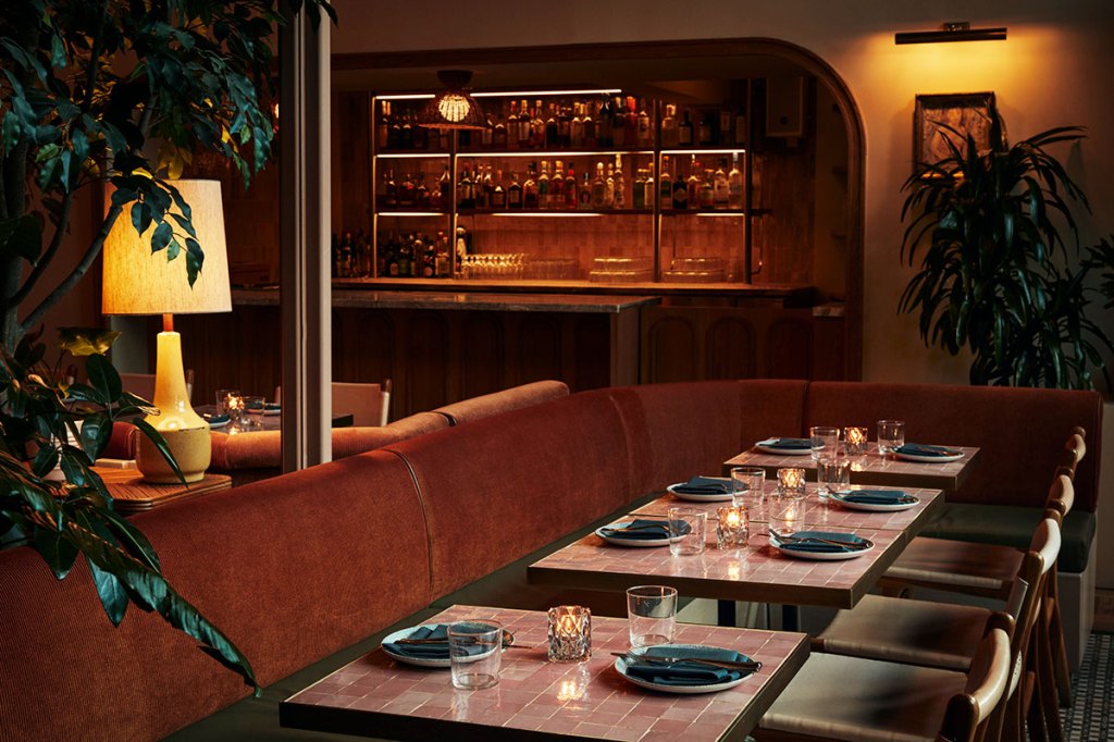 Interior of K'Far with tables laid for evening diners.