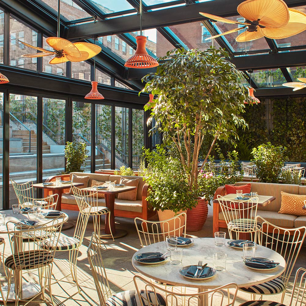 Sunlight pours into the glass-roofed interior of K'Far at The Hoxton, Williamsburg