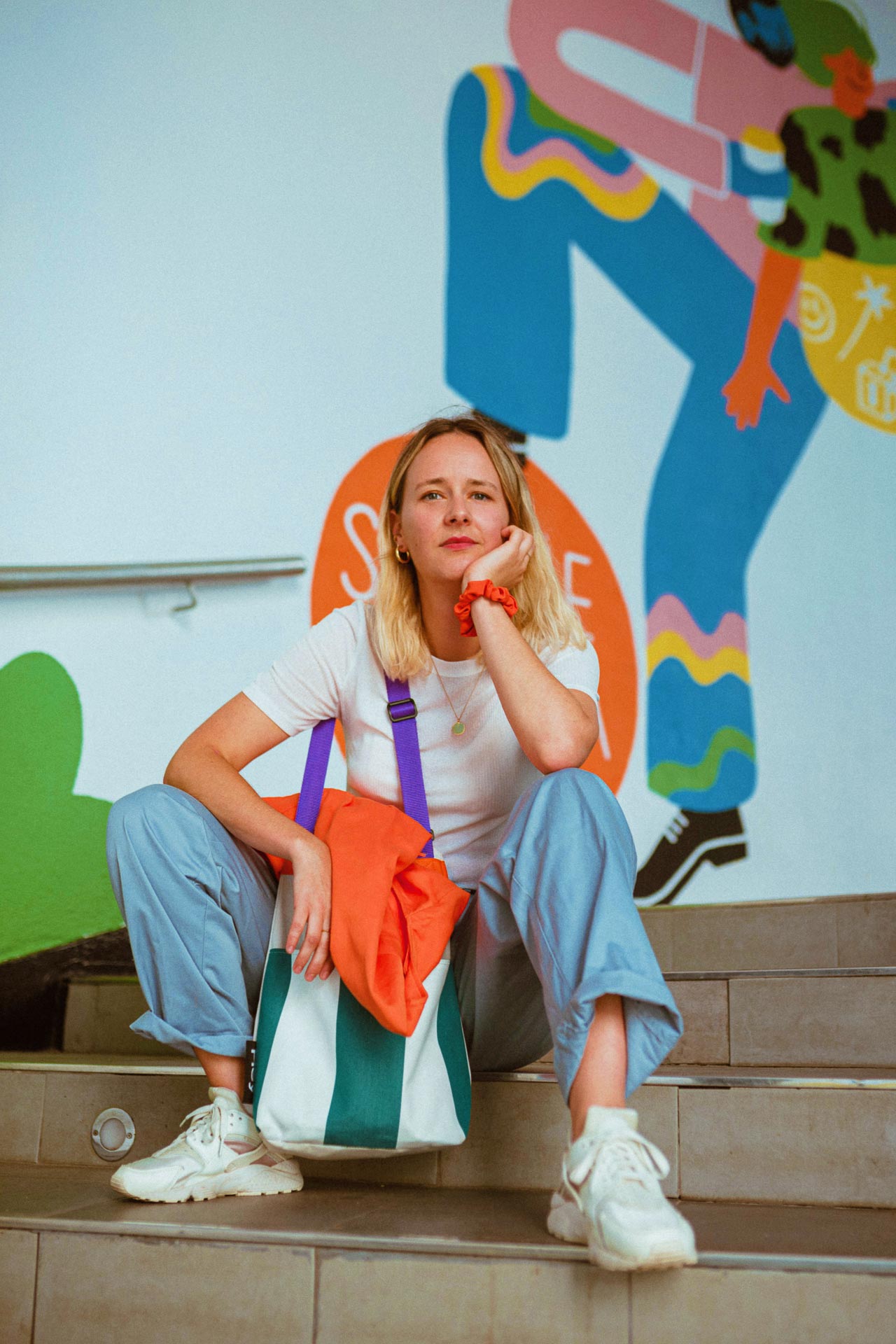 Barcelona-based illustrator and muralist Perrine Honoré sits before her art.