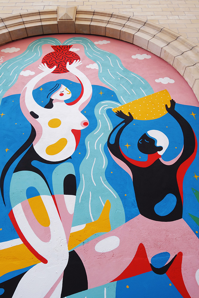 Mural showing a woman lifting an overflowing cask of water