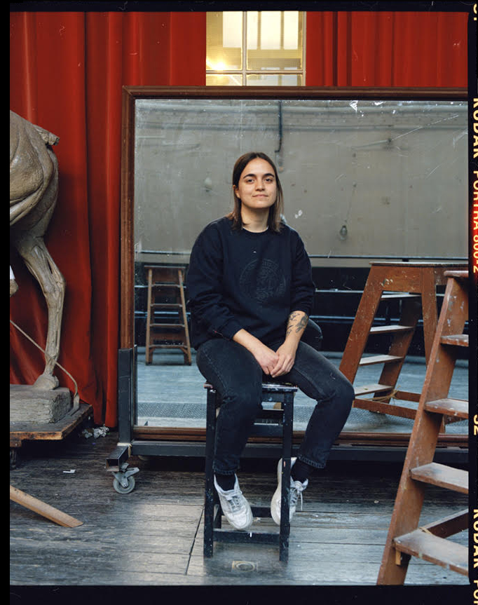 Artist Sofia Clausse sits in her studio.
