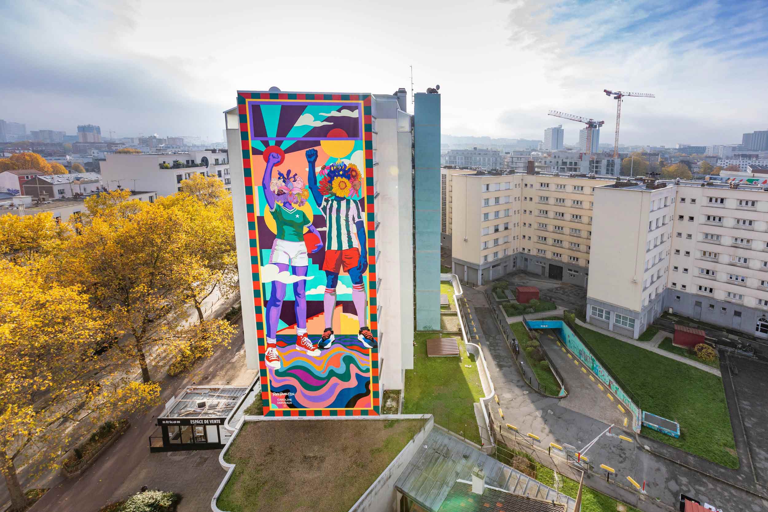 Giant colourful mural on the side of a tower block.